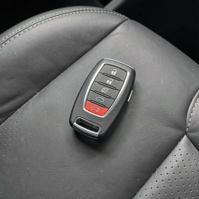a car key fob on a leather seat