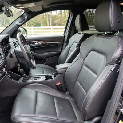 a car interior with stitched leather seats