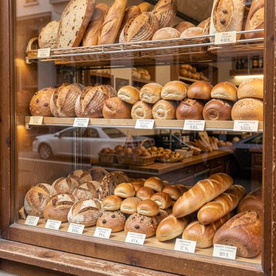 a bakery window full of breads and buns