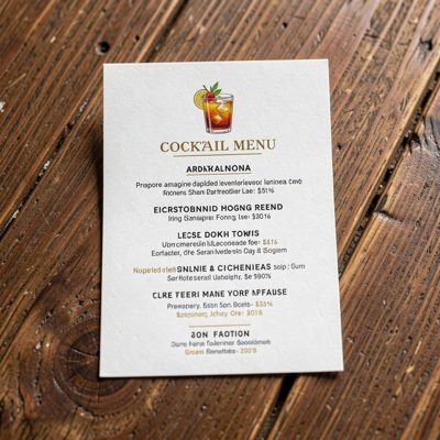 a cocktail menu on a small card