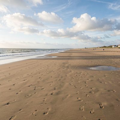 a wide empty beach at low tide