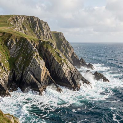 a rocky headland with white water below