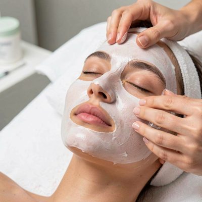 a facial treatment with a mask being applied