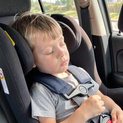 a child asleep in a car seat