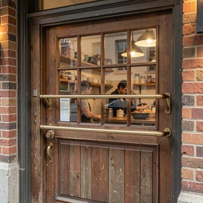 a cafe kitchen door with an order rail