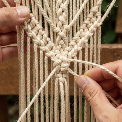 a macrame hanging being knotted