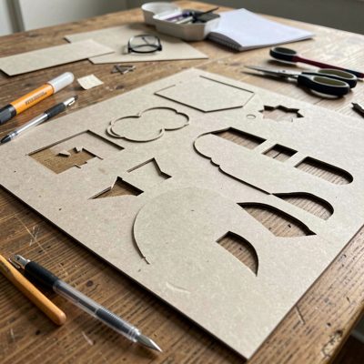 a paper craft table with cut shapes