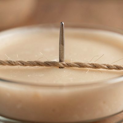 a candle wick being centred with a peg