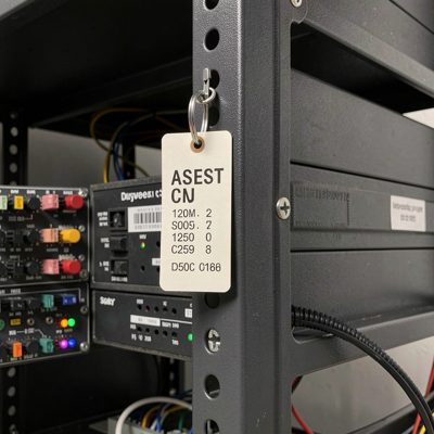 an asset tag stuck to the side panel of a rack