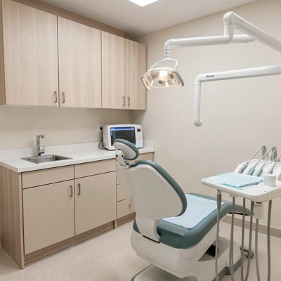 a dental surgery with cabinets and a sink