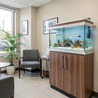 a dental practice waiting room with a fish tank