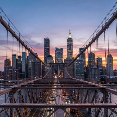 a skyline seen from a bridge at dusk