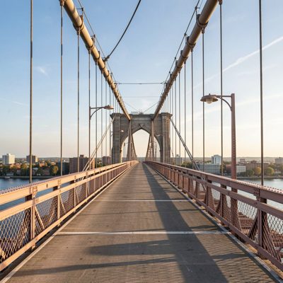 a bridge walkway with cables overhead