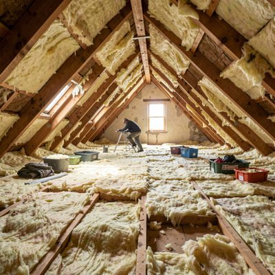 an insulation being fitted in a loft