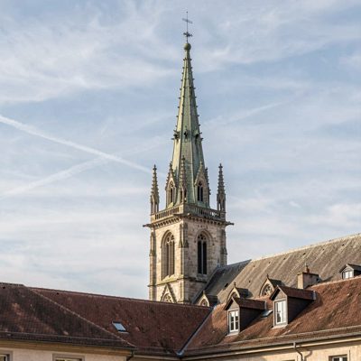 a cathedral spire rising above a rooftop line