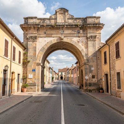 an old town gate arch over a road