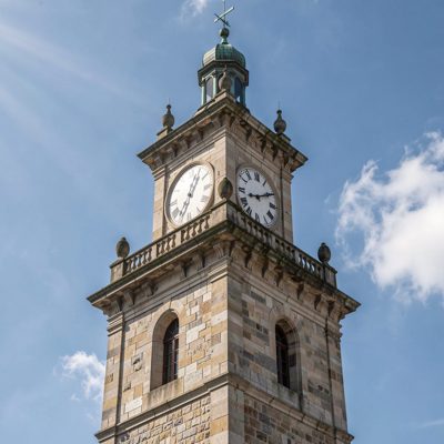 a town hall clock tower above a square