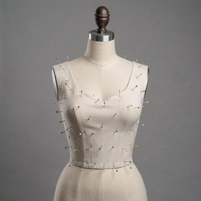 a model of a dress form with pinned fabric
