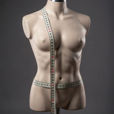 a mannequin torso with a tape measure around it