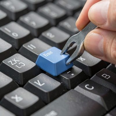 a keyboard keycap being pulled with a puller