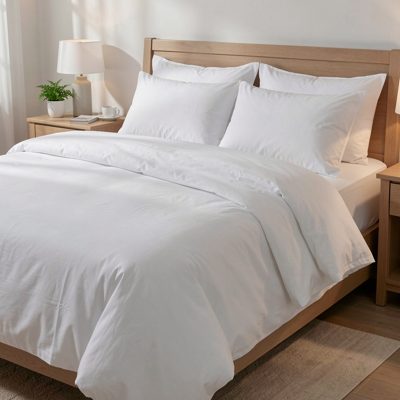 a bed made up with fresh cotton sheets