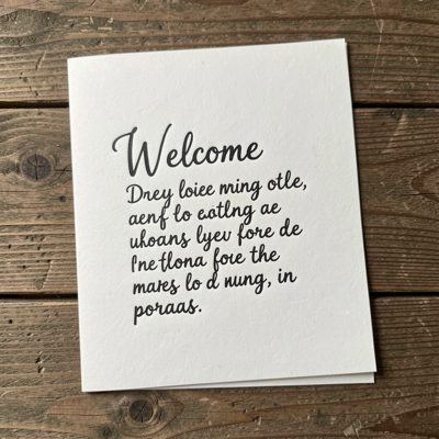 a handwritten welcome note on a card
