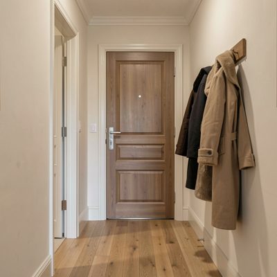 a hallway with coats hung by the door