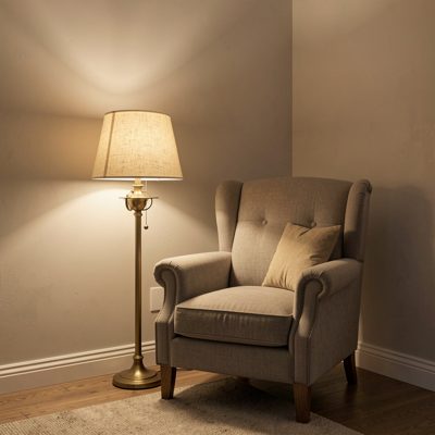 a lamp lit corner with an armchair