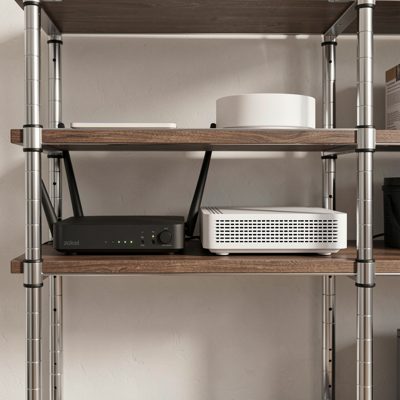 a rack shelf holding a modem and a router