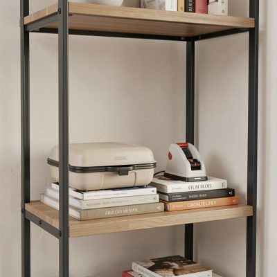 a home rack with a label maker on the shelf beside it