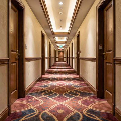 a hotel corridor with patterned carpet