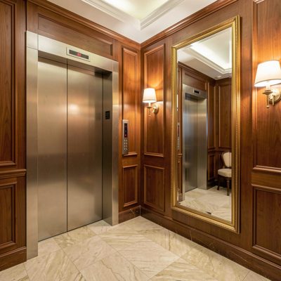 a hotel lift lobby with a mirror