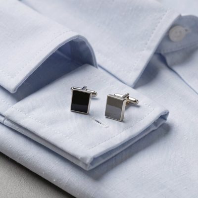 a set of cufflinks on a folded shirt