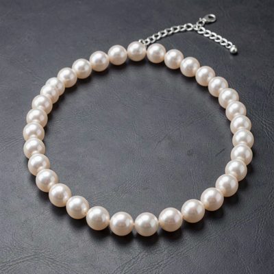 a pearl necklace laid in a curve