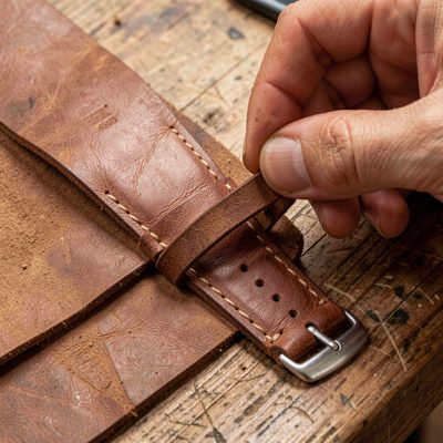 a leather watch strap being fitted
