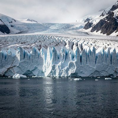 a glacier front meeting dark water