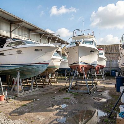 a boatyard with hulls propped for repair