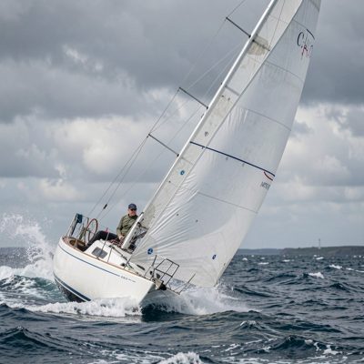 a sailing boat heeling in a stiff breeze