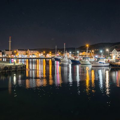 a harbour at night with lights on the water