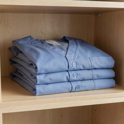 a set of scrubs folded on a shelf