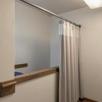 a treatment room with a curtain rail