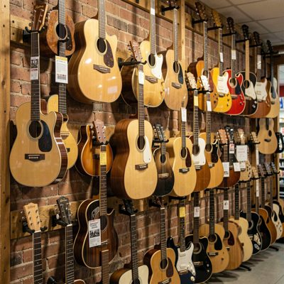 a music shop wall hung with guitars