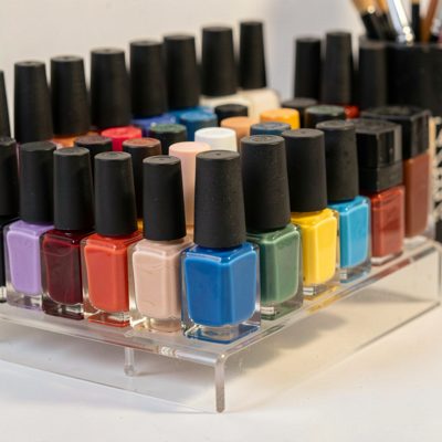 a rack of nail polish bottles in graduated colours