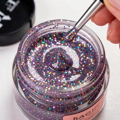 glitter polish being applied over a base coat