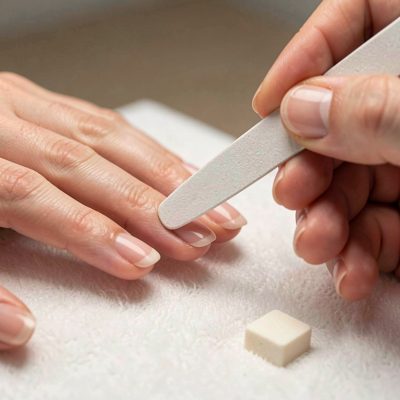 a nail buffer being used on a natural nail