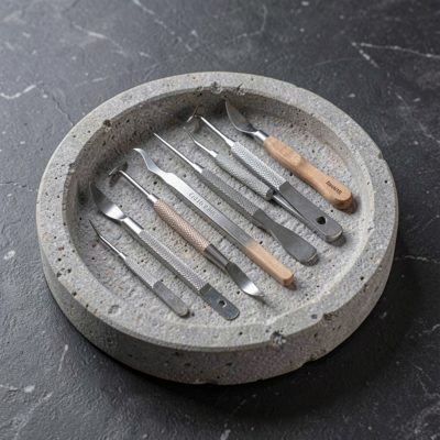 a stone tray of sterilised nail tools laid out