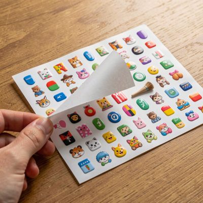 a sheet of nail stickers being peeled