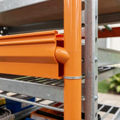 an orange plastic fibre raceway with a downspout into a rack