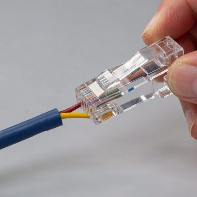 an rj45 plug being crimped onto a stripped cable