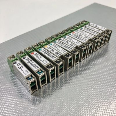 a row of sfp modules laid out on an antistatic mat